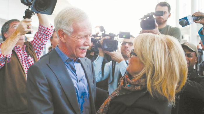 Captain Chesley &quot;Sully&quot; Sullenberger (left) embraces a passenger from the US Airways Flight 1549 which landed safely on the Hudson River in 2009, before a news conference marking the fifth anniversary of the incident, in New York January 15, 2014