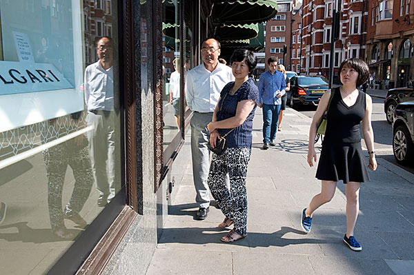 Chinese tourists check out Harrods' window display