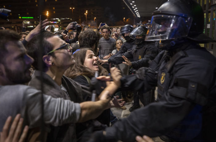 Catalan pro-independence protesters scuffle with by Catalan police, as they try to block the entrance of the main train station, during a demonstration in Barcelona, Spain, Monday, Oct. 28, 2019. The protest organised by the Committees for the Defense of the Republic, also known as CDRs, have prompted police to form a security perimeter around the train station to block demonstrators from disrupting travellers. (AP Photo/Emilio Morenatti)