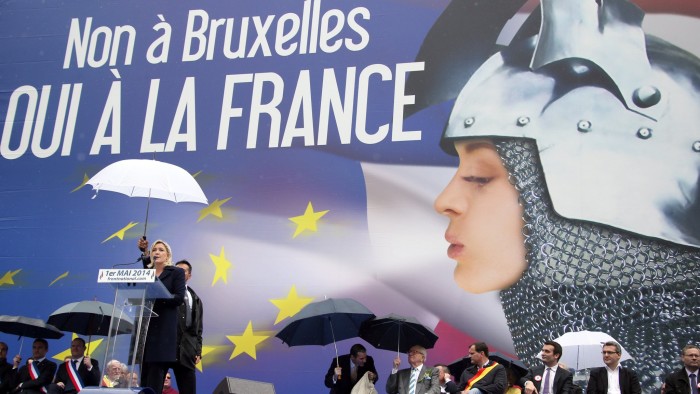 France's far-right National Front (FN) leader Marine Le Pen addresses supporters in front of a poster depicting Joan of Arc (Jeanne d'Arc) and reading &quot;No to Brussels, yes to France&quot; during a May Day rally in Paris on May 1, 2014. AFP PHOTO / KENZO TRIBOUILLARD (Photo credit should read KENZO TRIBOUILLARD/AFP/Getty Images)