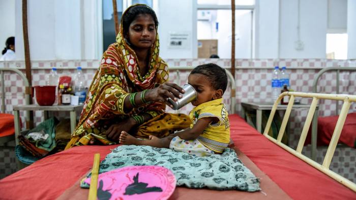 To go with 'India-Social-Poverty-Malnutrition' FEATURE by Agnes BUN In this photograph taken on October 19, 2015, two year old malnourished Indian child Dinesh Pandit is fed by his mother Aasha Devis Pandit as he sits on a bed at the Nutritional Rehabilitation Centre at Darbhanga Medical College and hospital in Darbhanga in the eastern Indian state of Bihar. While India's economy is growing at a healthy rate, it still lags behind some of its poorer neighbours on the nutritional status of children. The recently-released 2015 Global Nutrition Report showed that although child undernutrition rates have been declining in India, it is still home to over 40 million stunted children. AFP PHOTO/MONEY SHARMA / AFP PHOTO / MONEY SHARMA (Photo credit should read MONEY SHARMA/AFP/Getty Images)