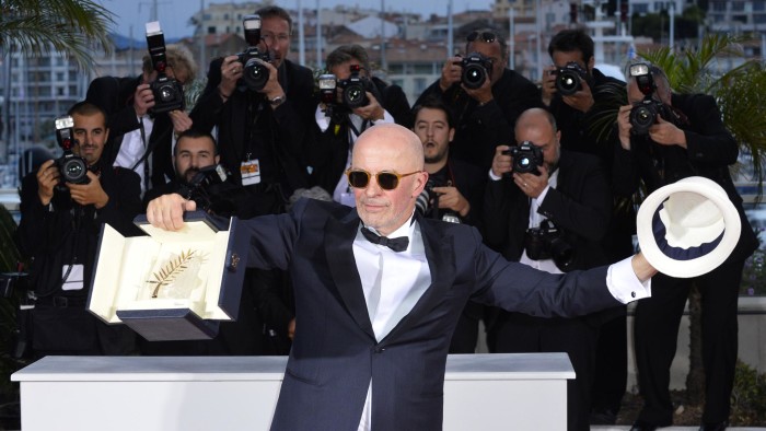 Director Jacques Audiard holds the Palme díOr award for the film Dheepan as he poses for photographers during a photo call following the awards ceremony at the 68th international film festival, Cannes, southern France, Sunday, May 24, 2015. (AP Photo)