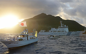 Japanese and Chinese boats sail past one of the disputed Senkaku/Diaoyu islands last year