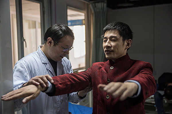 Surgeon Sailike Duishanbai checks the progress of patient Tang Zhu