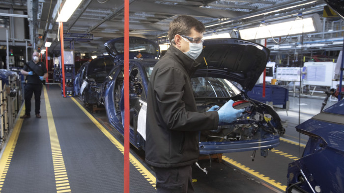 Members of staff working between two-metre wide designated work stations on a car assembly line at the Vauxhall car factory during preparedness tests and redesign ahead of re-opening following the COVID-19 outbreak. Located in Ellesmere Port, Wirral, the factory opened in 1962 and currently employs around 1100 workers. It ceased production on 17 March 2020 and will only resume work upon the advice of the UK Government, which will involve stringent physical distancing measures being in place across the site. (Photo by Colin McPherson/Corbis via Getty Images)