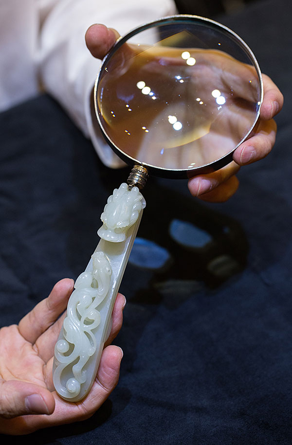 Magnifying glass with a Qing dynasty jade belt buckle