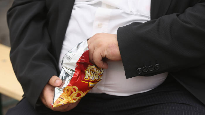 A man with a large belly eats junk food on May 23, 2013 in Leipzig, Germany. (Photo by Sean Gallup/Getty Images)