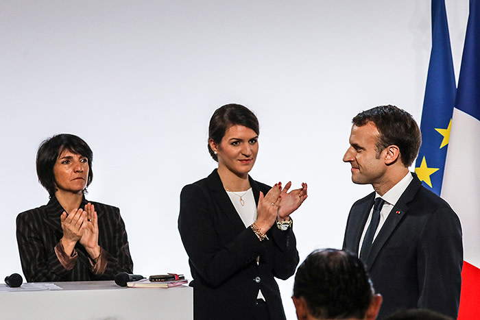 (Left to right) French patron of Women Safe Florence Foresti, with French minister for equality Marlene Schiappa and French President Emmanuel Macron / AFP PHOTO / POOL / LUDOVIC MARIN (Photo credit should read LUDOVIC MARIN/AFP/Getty Images)