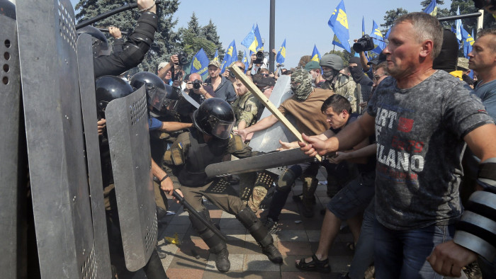 Protesters clash with police in Kiev on Monday after parliament gave initial approval to greater powers for separatist eastern regions