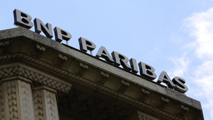 The logo of French bank BNP Paribas is seen above the facade of their central Paris agency...The logo of French bank BNP Paribas is seen above the facade of their central Paris agency June 30, 2014. The U.S. Justice Department is expected to announce on Monday a settlement with BNP Paribas involving a record fine of nearly $9 billion over alleged U.S. sanctions violations by France’s biggest bank, sources familiar with the matter said. REUTERS/John Schults (FRANCE - Tags: BUSINESS LOGO)