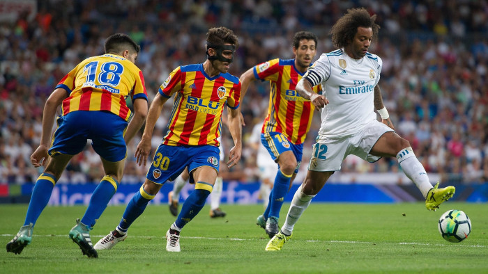 MADRID, SPAIN - AUGUST 27: Marcelo of Real Madrid CF controls the ball beside Nacho Vidal of Valencia CFduring the La Liga match between Real Madrid CF and Valencia CF at Estadio Santiago Bernabeu on August 27, 2017 in Madrid, Spain . (Photo by Denis Doyle/Getty Images)