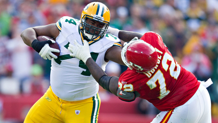 Marshall Newhouse #74 of the Green Bay Packers runs the ball after recovering a fumble and stiff arms Glenn Dorsey #72 of the Kansas City Chiefs at Arrowhead Stadium on December 18, 2011 in Kansas 