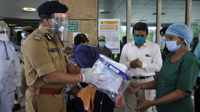 NOIDA, INDIA - APRIL 30: Police commissioner Alok Singh distributes the safety kits to the cleaning workers of district hospital, during a nationwide lockdown due to coronavirus pandemic, at Sector 30, on April 30, 2020 in Noida, India. (Photo by Sunil Ghosh/Hindustan Times via Getty Images)