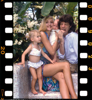 Jerry Hall, Mick Jagger and two of their children, Barbados, c1985