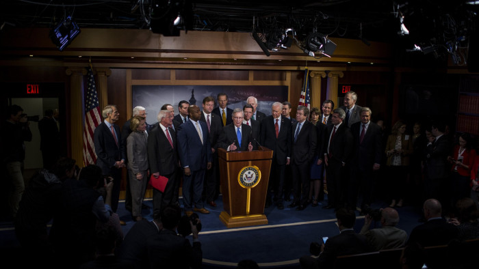 Senate Majority Leader Mitch McConnell, a Republican from Kentucky, center, speaks during a news conference with Senate Republicans after voting on the Tax Cuts and Jobs Act in the U.S. Capitol in Washington, D.C., U.S., on Tuesday, Dec. 20, 2017. Senate Republicans passed the most extensive rewrite of the U.S. tax code in more than 30 years, a bill that delivers a deep, permanent tax cut for corporations and shorter-term relief for individuals. Photographer: Zach Gibson/Bloomberg