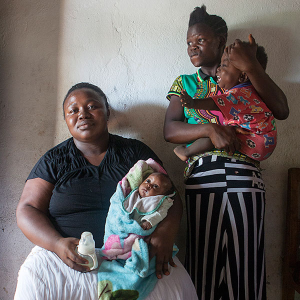 Massa Amadu with three of her adopted children — Hassan, five weeks, Kadiatu 15, and Joseph, 18 months