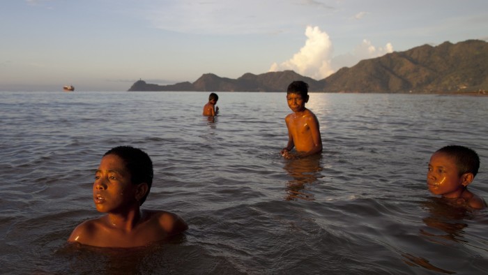 DILI, EAST TIMOR - APRIL 18 : East Timorese boys swim in the ocean by a city beach April 18, 2012 in Dili, East Timor. Millions have been spent on aid during the first 10 years as the country moves towards more stability and the long road to prosperity. East East Timor has a high rate of unemployment. Only 29% of the labor force is in paid employment while agriculture remains the primary livelihood activity for rural Timorese. Life expectancy is 62 years and forty five per cent of children in the country are underweight for their age. (Photo by Paula Bronstein/Getty Images)