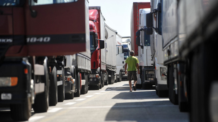 A truck driver walks on July 3, 2013 as he waits with colleagues near the Batrovci border crossing between Serbia and Croatia. Trucks were backed up for 15-kilometres (nine-miles) at Serbia's border with Croatia on July 2 as Croatian customs officers struggled with technical problems linked to the country joining the EU on July 1. Some 1,200 drivers from Balkan countries and beyond were stuck at the Batrovci border crossing, waiting for the Croatian customs system to be successfully synchronized with the European Union network. AFP PHOTO / ANDREJ ISAKOVIC (Photo credit should read ANDREJ ISAKOVIC/AFP via Getty Images)