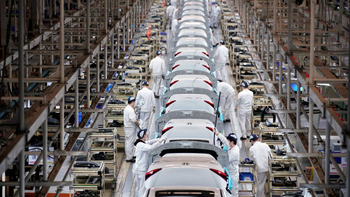 Employees work on a production line inside a Dongfeng Honda factory after lockdown measures in Wuhan, the capital of Hubei province and China's epicentre of the novel coronavirus disease (COVID-19) outbreak, were further eased, April 8, 2020. REUTERS/Aly Song