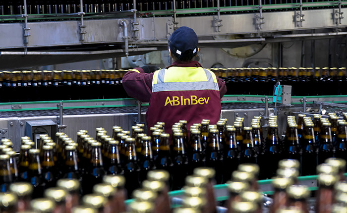 A worker checks bottles of Taller lager as they move along a conveyor belt on the production line at the OAO SUN Inbev beer plant, a unit of Anheuser-Busch InBev NV, in Chernihiv, Ukraine, on Friday, March 3, 2017. SUN InBev brews both national and international beer brands including Bud, Stella Artois and Corona. Photographer: Vincent Mundy/Bloomberg