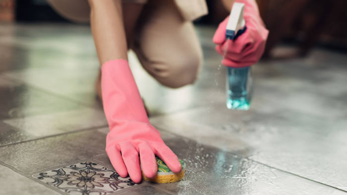 Housework and housekeeping concept. Woman cleaning floor with mop indoors