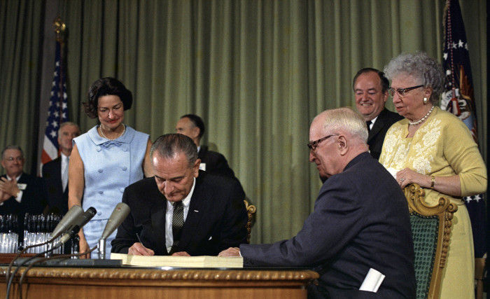 President Lyndon Johnson signing Medicare Bill, Independence, Missouri, Harry Truman looks on, 30 Jul 1965. (Photo by: Universal History Archive/Universal Images Group via Getty Images)