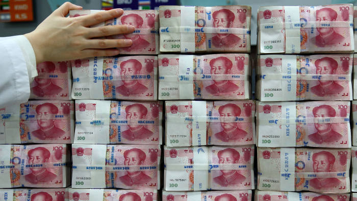 Chinese one-hundred yuan banknotes are stacked for a photograph at the Korea Exchange Bank headquarters in Seoul, South Korea, on Thursday, Feb. 27, 2014