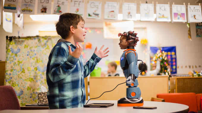 Devin Chaplin, 7, plays a game of "Red Light, Green Light" with Milo, the robot, during some exercises in Julie Jeffcoat's classroom at Kingsbury Elementary.