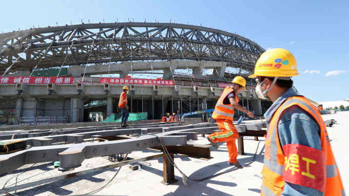 Workers are seen at the construction site of the National Speed Skating Oval, one of the venues for the 2022 Winter Olympics, in Beijing, China May 21, 2019. Picture taken May 21, 2019. China Daily via REUTERS ATTENTION EDITORS - THIS IMAGE WAS PROVIDED BY A THIRD PARTY. CHINA OUT. NO COMMERCIAL OR EDITORIAL SALES IN CHINA. - RC1D1C07D0C0
