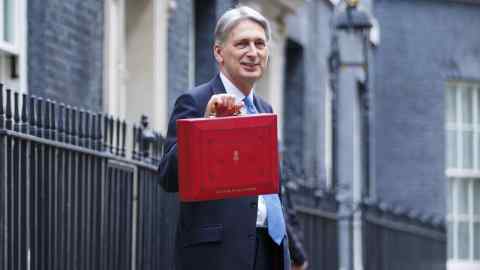 Chancellor of the Exchequer Philip Hammond poses outside No 11, Downing Street before presenting the government's new budget plan to the Parliament on November 22, 2017.