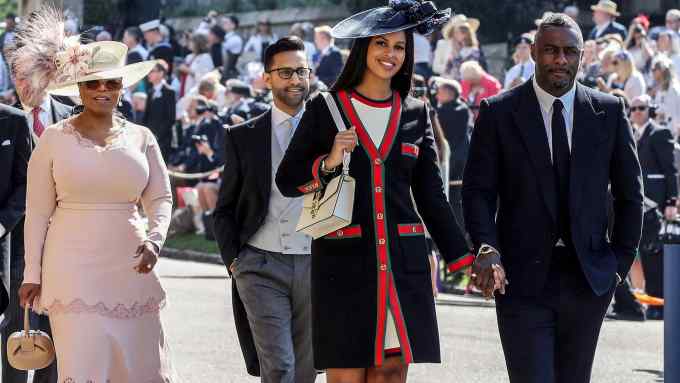 British actor Idris Elba (R) arrives with his fiancee Sabrina Dhowre (2R) followed by Prince's Harry's friend, British singer James Blunt (L) and US talk show host Oprah Winfrey (2L) for the wedding ceremony of Britain's Prince Harry, Duke of Sussex and US actress Meghan Markle at St George's Chapel, Windsor Castle, in Windsor, on May 19, 2018. (Photo by Chris Radburn / POOL / AFP) (Photo credit should read CHRIS RADBURN/AFP/Getty Images)