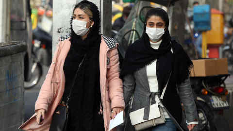 Mandatory Credit: Photo by ABEDIN TAHERKENAREH/EPA-EFE/Shutterstock (10505949m) Iranians wearing masks walk on a street of Tehran, Iran, 15 December 2019. Reports state Tehran's air pollution is reaching hazardous level prompting the government to declare one-day closure for schools in Tehran. Authorities have urged elderly and sick people as well as children to stay indoors. Air pollution in Tehran, Iran Islamic Republic Of - 15 Dec 2019