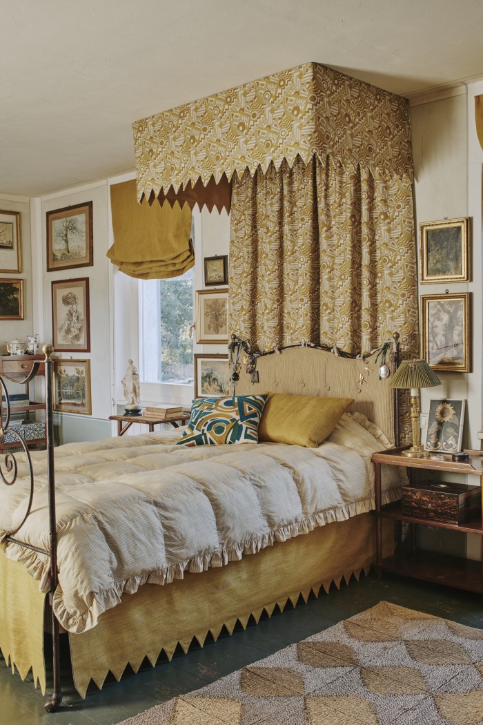 Forquet’s Tuscany home. The bedskirt fabric is Canvas in Sahara. The canopy is in Zig Zag Linen in Sahara. The headboard fabric is Sahara Painted Elements. The cushions are covered in (from left) Trepak Embroidery in Summer, and Sahara Canvas