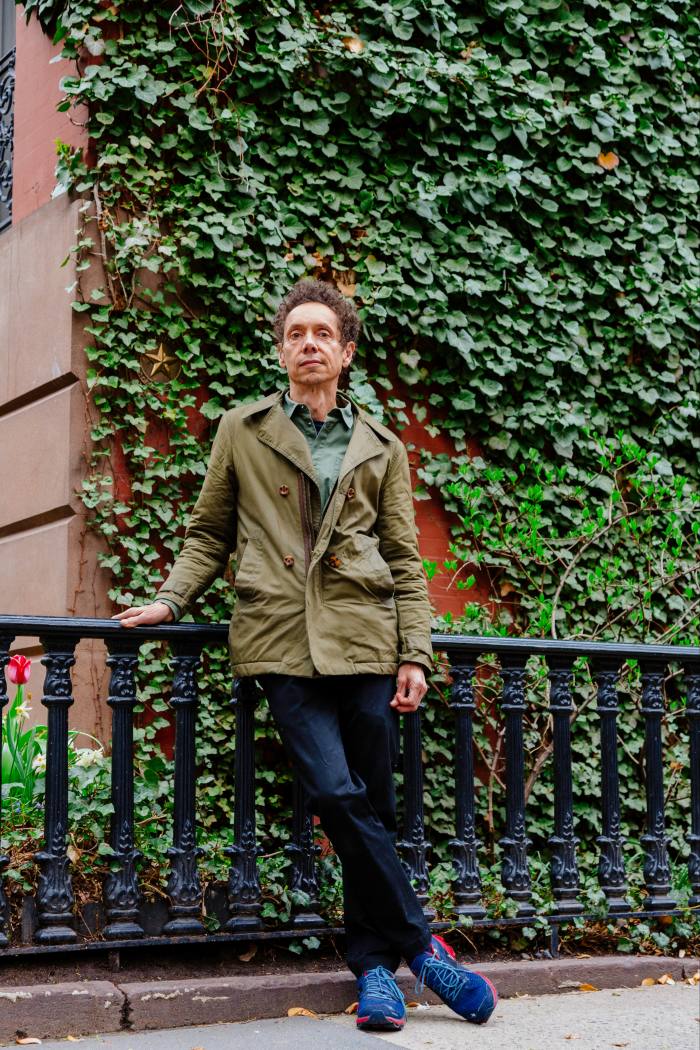 Malcolm Gladwell photographed  outside a brownstone in New York