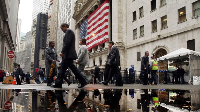 People walk past the New York Stock Exchange