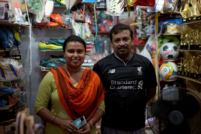 Mousumi and Arup Karmaker at their hole-in-the-wall sporting goods shop
