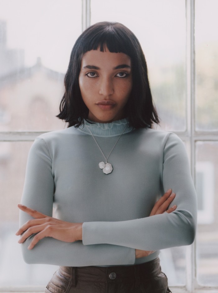 Akima wears Harry Winston white-gold and diamond Emerald Signature secret watch (worn either on wrist, as pendant or as brooch), POA. Hermès silk knit sweater, £1,000. Frame leather skirt, €1,099