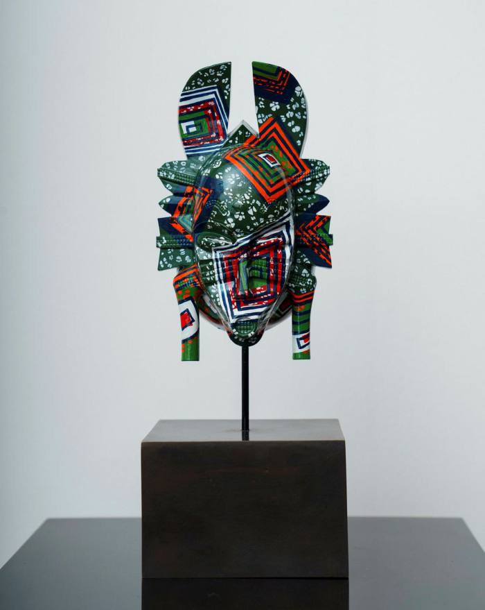 An African mask shape but with bright patterns
