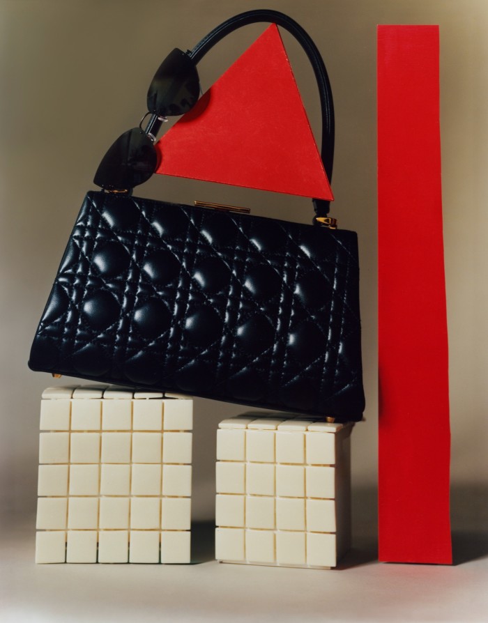 Dior cannage leather Top Handle bag, £4,600. Lindberg titanium glasses, £540