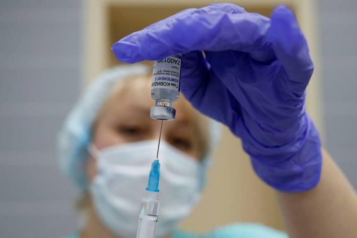 A medical worker fills a syringe with the Sputnik V (Gamaleya) vaccine before administering an injection in Moscow, Russia