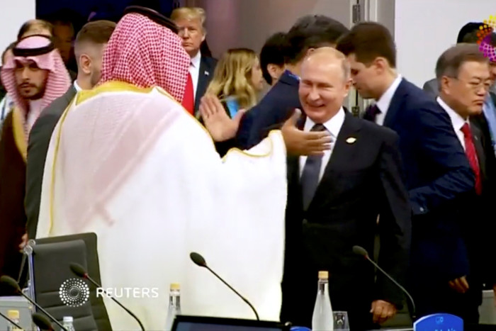 Prince Mohammed and Vladimir Putin smile broadly as they greet each other