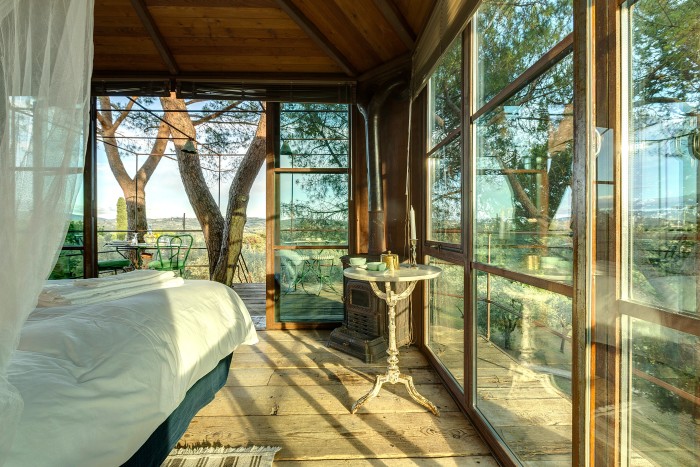 The treehouse boasts triple-aspect windows in the bedroom