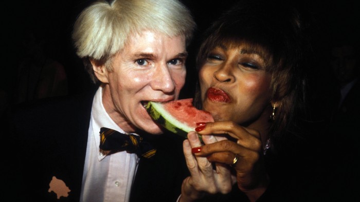 Warhol and Tina Turner share a slice of watermelon, 1981
