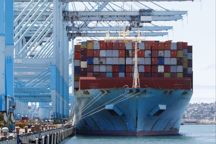 Shipping containers are unloaded from the Maersk Edinburgh cargo ship at the APM shipping terminal in the Port of Los Angeles