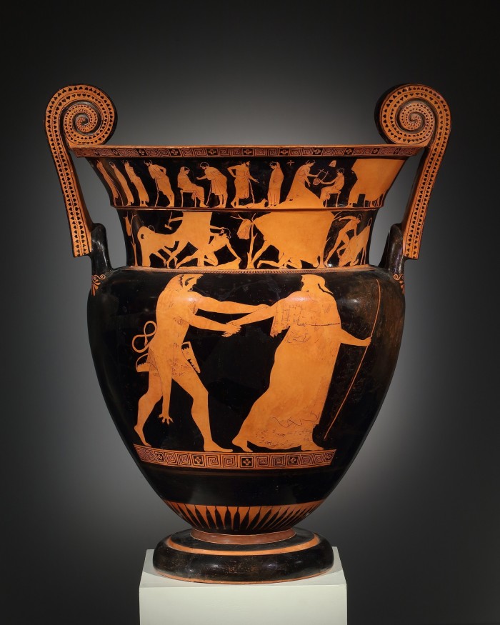  A large black vase with two red figures on it, one apparently grabbing the other 