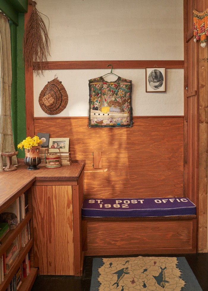 The bedroom’s Douglas fir and Homasote wall, on which hangs a cedar-root hat and an antique vest 