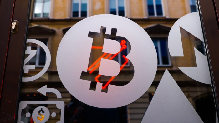 A bitcoin symbol is seen on a money exchange point in Warsaw, Poland 