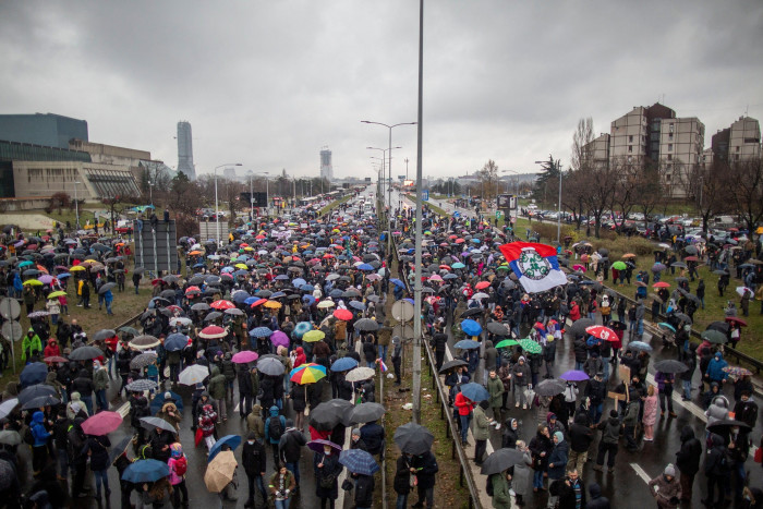 People gather to block the highway, in Belgrade, on December 11, 2021 to protest against the Anglo-Australian company Rio Tinto’s plan to open a lithium mine in the country