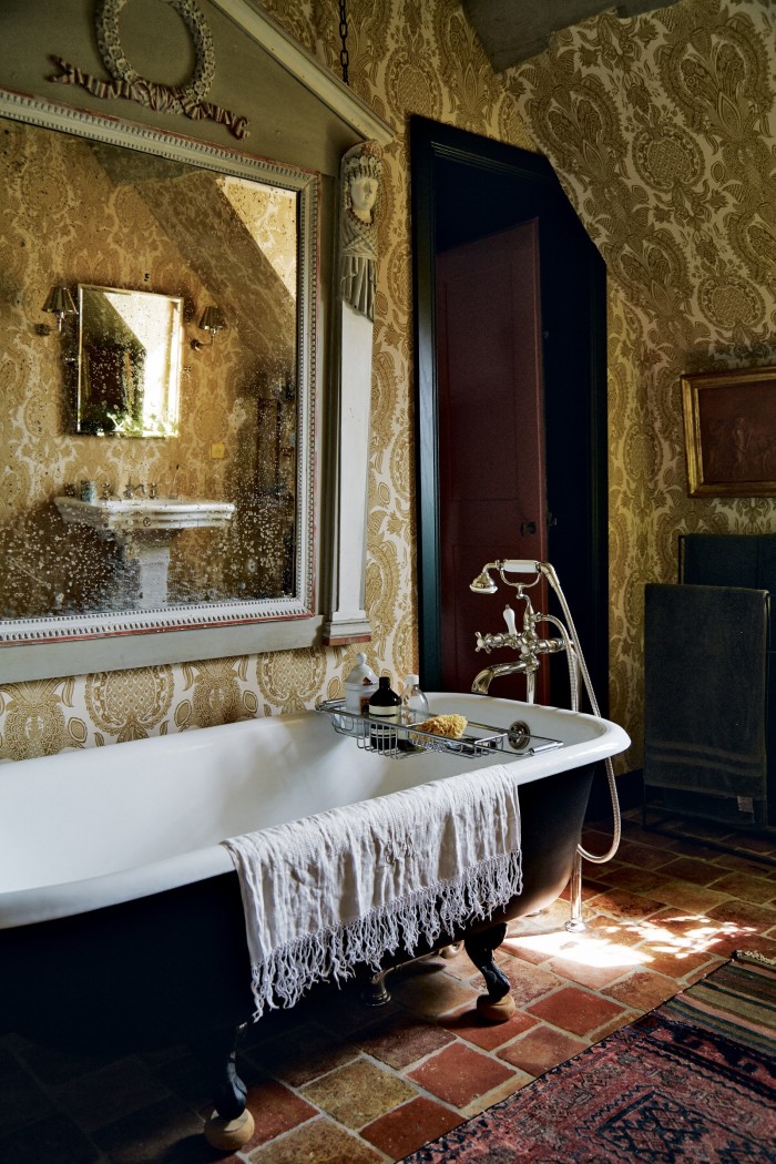 An antique bath and salvaged tiles in the master ensuite