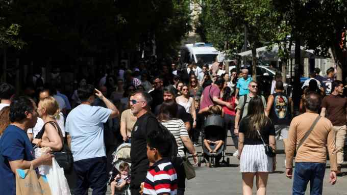 People outside in Madrid in higher than normal April temperatures